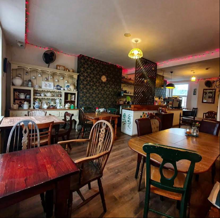 Wide view of Tea Hive dining room with festoon lights
