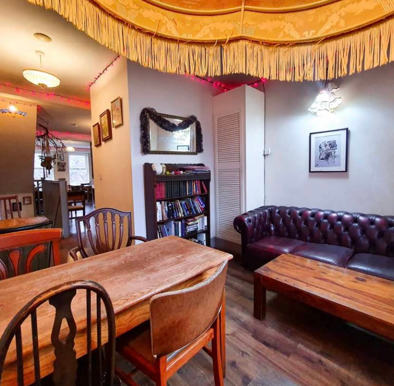Lounge area with chesterfield sofa and bookshelf